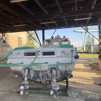 an abandoned boat repair shop with a police boat