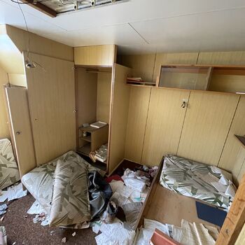 an abandoned boat repair shop with a police boat