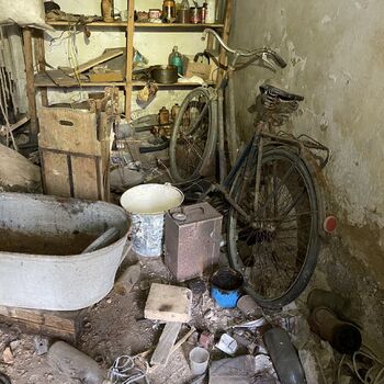Abandoned farmhouses side by side.