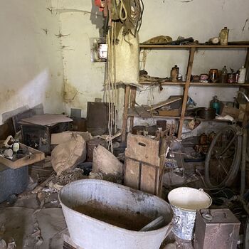 Abandoned farmhouses side by side.