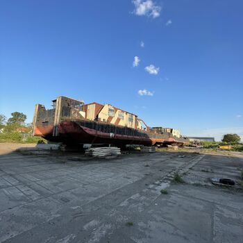 an abandoned boat repair shop with a police boat
