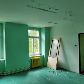 An abandoned apartment building in the village.