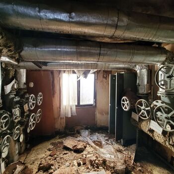 It's an inconspicuous little cell between the boiler room and the building.