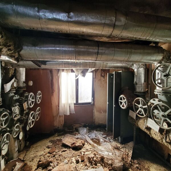 It's an inconspicuous little cell between the boiler room and the building.