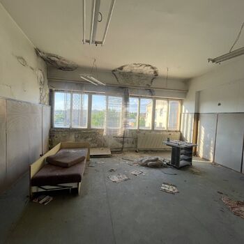 an abandoned boat repair shop with a police boat