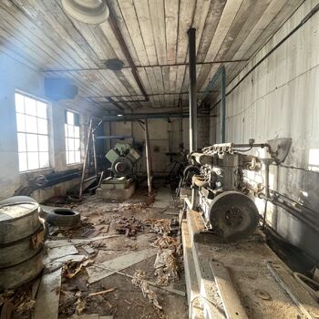 an abandoned boat repair shop with a police boat