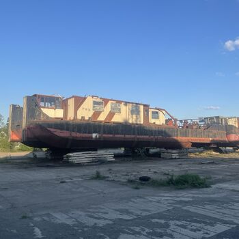 an abandoned boat repair shop with a police boat
