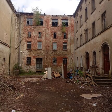Dilapidated two tenements next to a semi-dilapidated factory.2024 Dilapidated two tenements next to a semi-dilapidated factory.2024