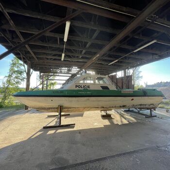 an abandoned boat repair shop with a police boat