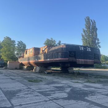 an abandoned boat repair shop with a police boat