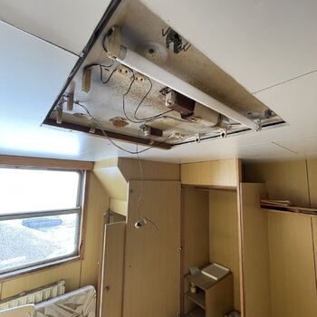 an abandoned boat repair shop with a police boat