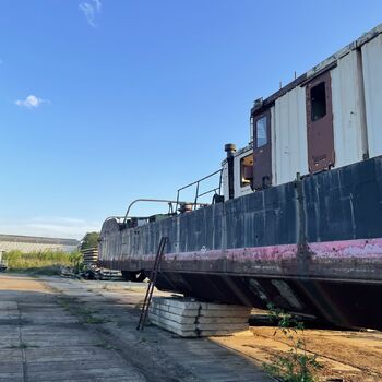 an abandoned boat repair shop with a police boat